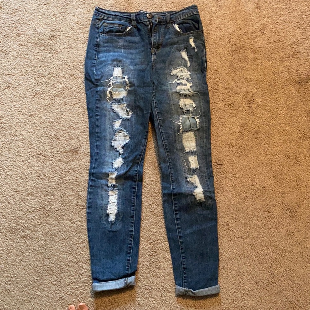 Very distressed skinny blue jeans